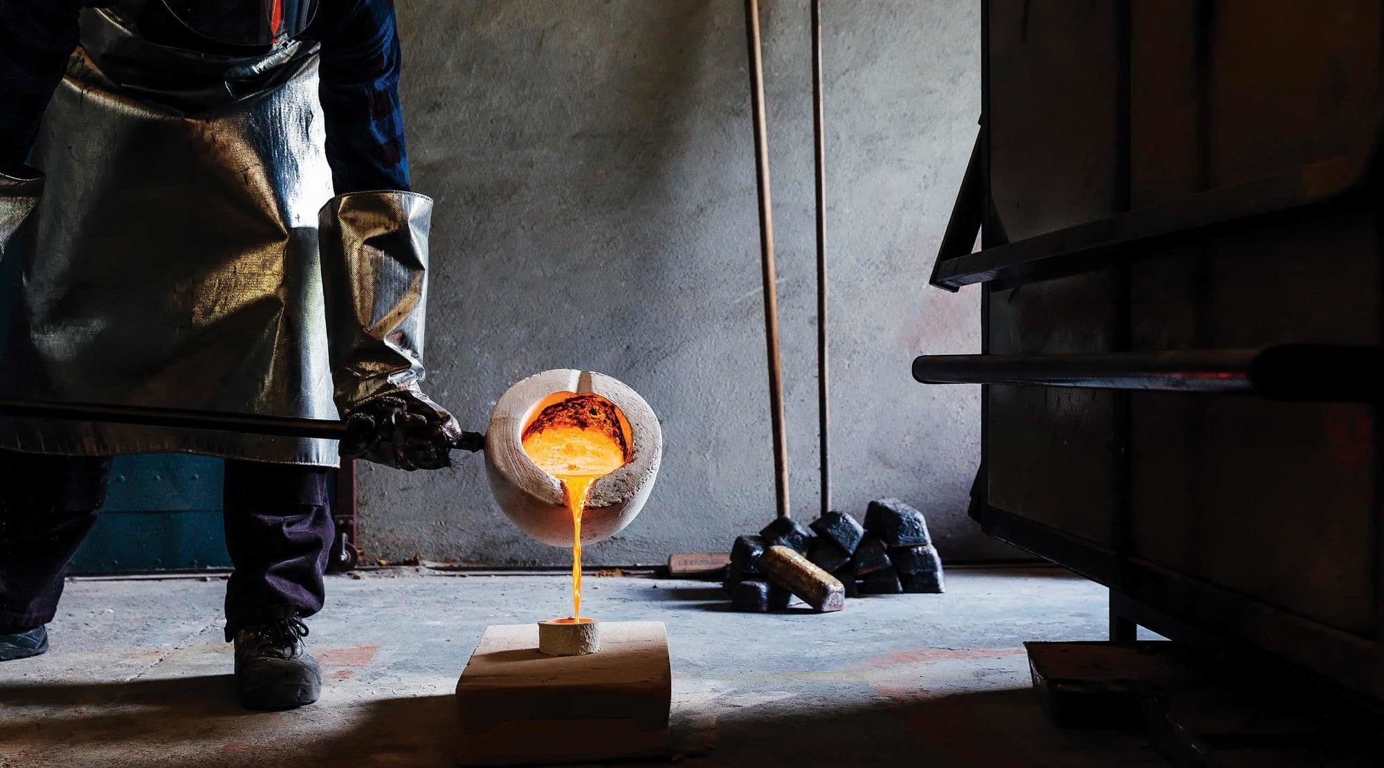 Molten brass is hand-poured into the china mould and then broken out to begin tooling and polishing.